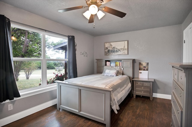 184 Wildflower Trl, Weatherford, TX 76087 - bedroom with baseboards, a textured ceiling, dark wood-type flooring, and ceiling fan