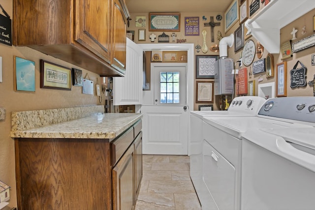 184 Wildflower Trl, Weatherford, TX 76087 - washroom featuring cabinet space, independent washer and dryer, and stone tile flooring