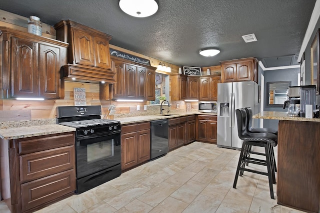 184 Wildflower Trl, Weatherford, TX 76087 - kitchen with a sink, visible vents, light stone countertops, black appliances, and premium range hood