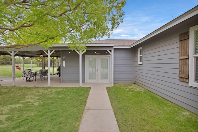 184 Wildflower Trl, Weatherford, TX 76087 - entrance to property with a lawn, a shingled roof, french doors, fence, and a patio