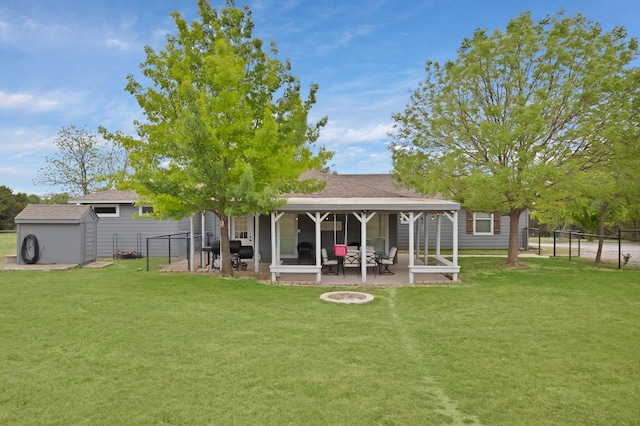 184 Wildflower Trl, Weatherford, TX 76087 - rear view of house with a fire pit, a patio area, a lawn, and a fenced backyard
