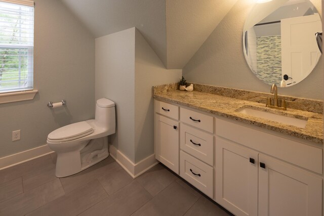 3050 County Road 3707, Bullard, TX 75757 - bathroom featuring toilet, tile patterned flooring, lofted ceiling, vanity, and baseboards