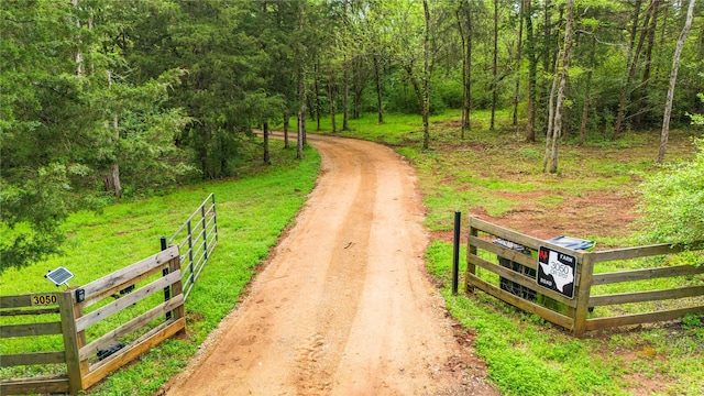 3050 County Road 3707, Bullard, TX 75757 - view of road featuring a wooded view and a gated entry