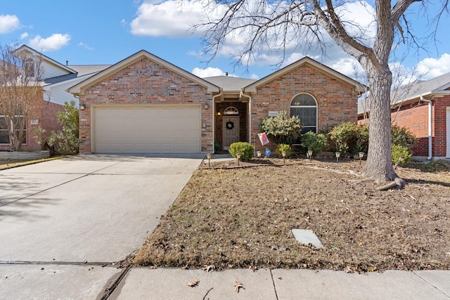 single story home featuring concrete driveway, an attached garage, and brick siding