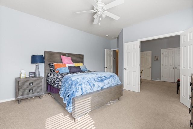 bedroom featuring light carpet, a ceiling fan, and baseboards