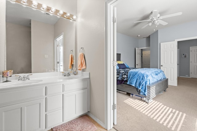 bathroom with double vanity, ensuite bath, a ceiling fan, and a sink