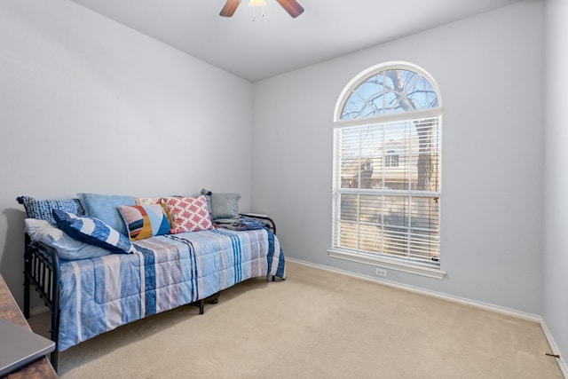 bedroom with a ceiling fan, baseboards, and carpet