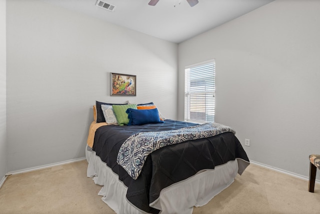 carpeted bedroom featuring visible vents, baseboards, and ceiling fan