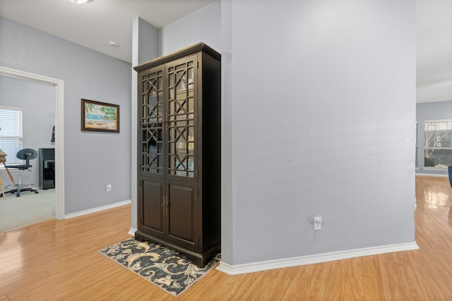 foyer entrance with light wood-style flooring and baseboards