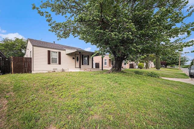 single story home featuring a front lawn and fence
