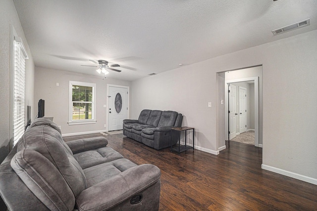 living room with dark wood finished floors, baseboards, a ceiling fan, and visible vents