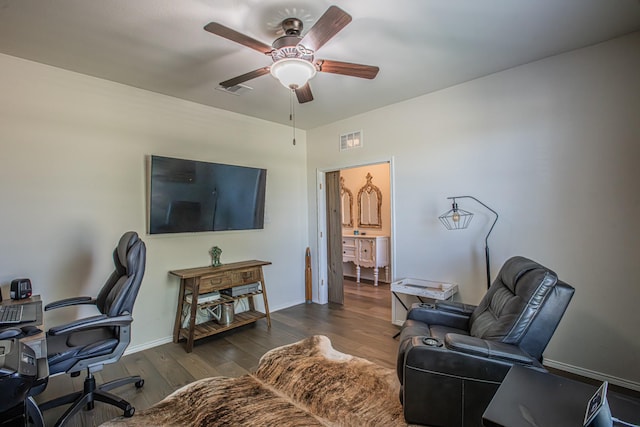 office area with baseboards, wood finished floors, visible vents, and ceiling fan