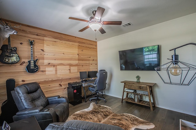 office area with baseboards, visible vents, wood walls, wood finished floors, and ceiling fan