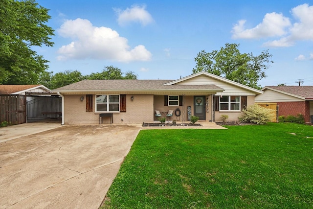 ranch-style house featuring fence, roof with shingles, brick siding, a front yard, and concrete driveway