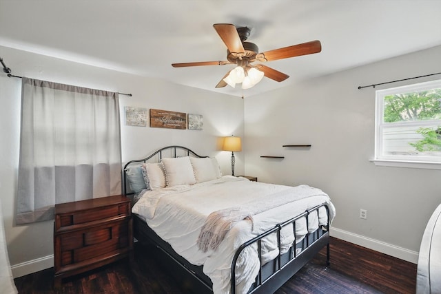 bedroom featuring baseboards, a ceiling fan, and wood finished floors