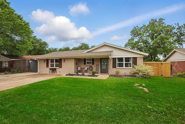 single story home with brick siding, a gate, and a front yard