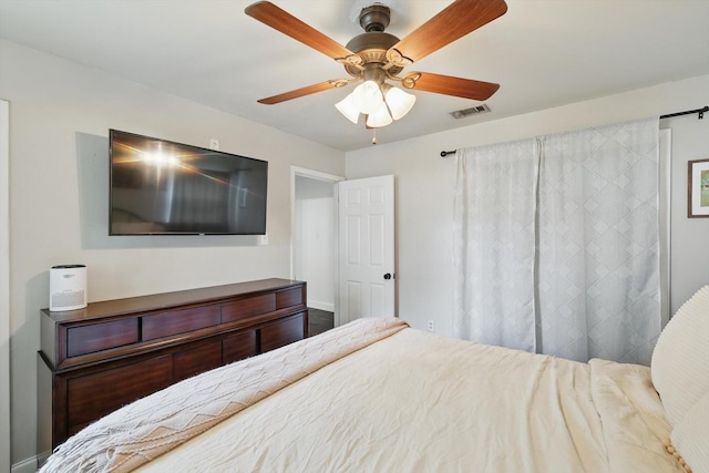 bedroom featuring a ceiling fan, baseboards, and visible vents