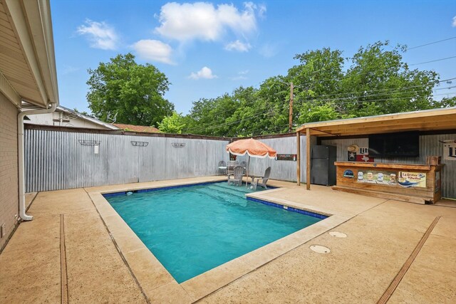 view of pool with a fenced in pool, a fenced backyard, and a patio area