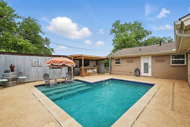 view of swimming pool featuring a patio, a fenced in pool, and fence