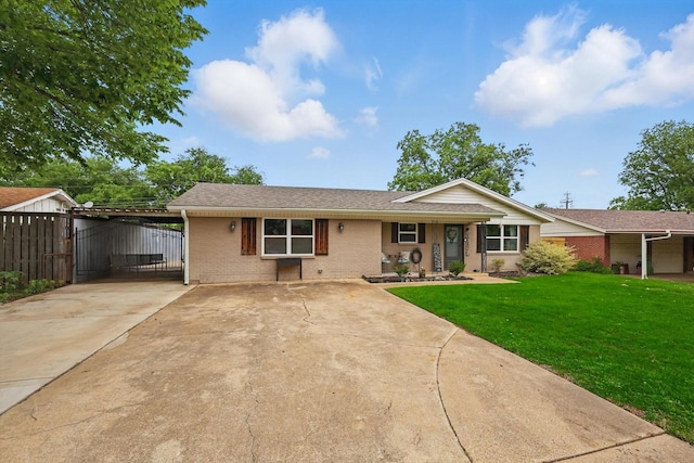 ranch-style home featuring fence, a front yard, brick siding, a porch, and driveway