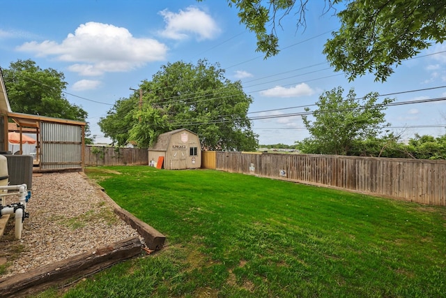 view of yard featuring an outdoor structure, a fenced backyard, and a shed
