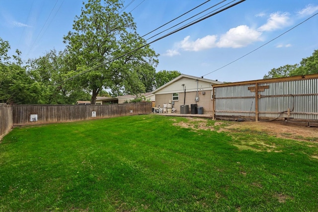 view of yard featuring a fenced backyard and central air condition unit