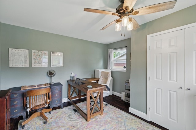 office area with baseboards, a ceiling fan, and wood finished floors