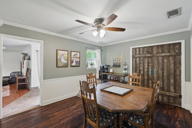 dining room featuring ornamental molding, a ceiling fan, wood finished floors, and visible vents