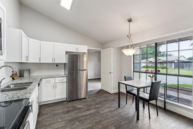 7012 Newberry Ct E, Fort Worth, TX 76120 - kitchen with a sink, tasteful backsplash, freestanding refrigerator, white cabinetry, and electric stove