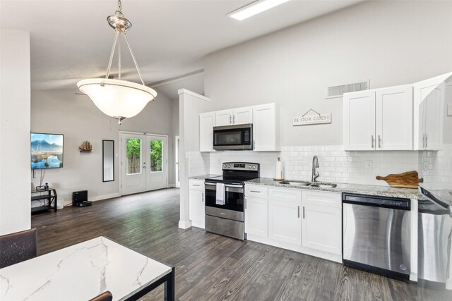 7012 Newberry Ct E, Fort Worth, TX 76120 - kitchen with high vaulted ceiling, stainless steel appliances, tasteful backsplash, and a sink
