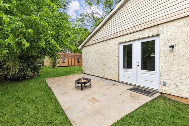 7012 Newberry Ct E, Fort Worth, TX 76120 - view of patio with an outdoor structure, a fire pit, and french doors