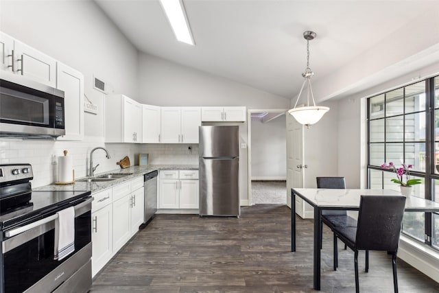 7012 Newberry Ct E, Fort Worth, TX 76120 - kitchen featuring a sink, stainless steel appliances, light stone counters, vaulted ceiling, and white cabinets