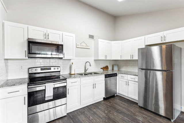 7012 Newberry Ct E, Fort Worth, TX 76120 - kitchen with white cabinetry, light stone countertops, appliances with stainless steel finishes, and a sink