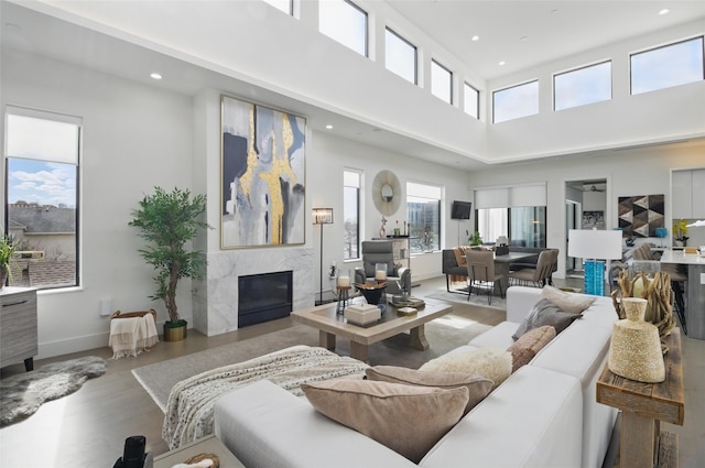 3923 Cole Ave Unit 303, Dallas, TX 75204 - living area with recessed lighting, a premium fireplace, wood finished floors, and a high ceiling