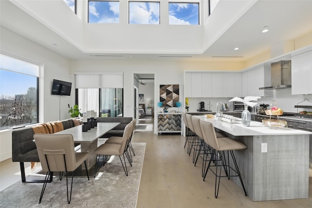 3923 Cole Ave Unit 303, Dallas, TX 75204 - dining room featuring recessed lighting, light wood finished floors, and a towering ceiling