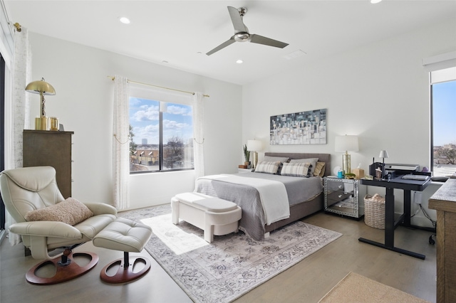 3923 Cole Ave Unit 303, Dallas, TX 75204 - bedroom with light wood finished floors, a ceiling fan, recessed lighting, and multiple windows