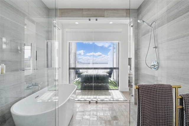 3923 Cole Ave Unit 303, Dallas, TX 75204 - full bathroom featuring a soaking tub and tiled shower