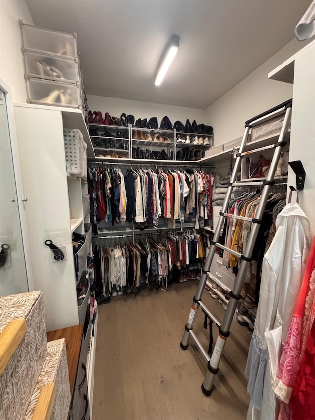 3923 Cole Ave Unit 303, Dallas, TX 75204 - walk in closet featuring wood finished floors