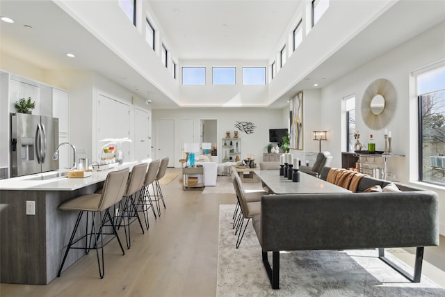 3923 Cole Ave Unit 303, Dallas, TX 75204 - dining space with recessed lighting, a towering ceiling, and light wood-style flooring