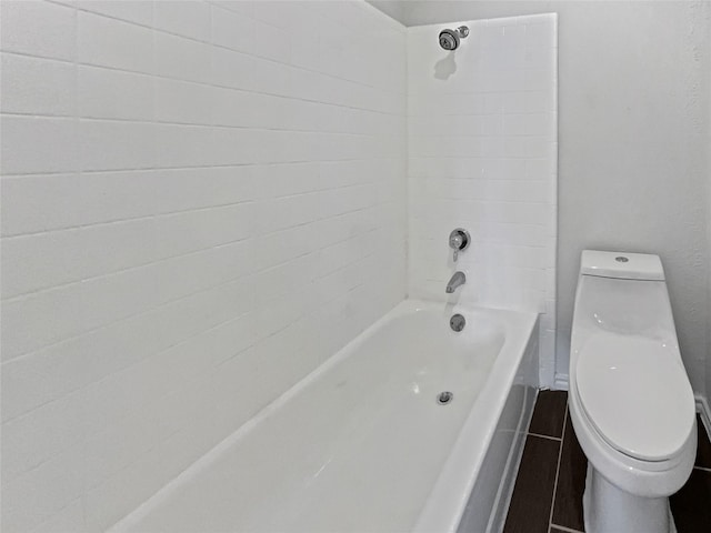 bathroom with toilet and shower / tub combination