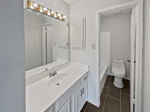 full bathroom featuring a tub to relax in, tile patterned floors, toilet, vanity, and baseboards