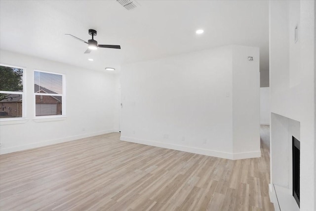 1941 Juniper Dr, Little Elm, TX 75068 - unfurnished living room featuring light wood-style flooring, a ceiling fan, baseboards, and recessed lighting
