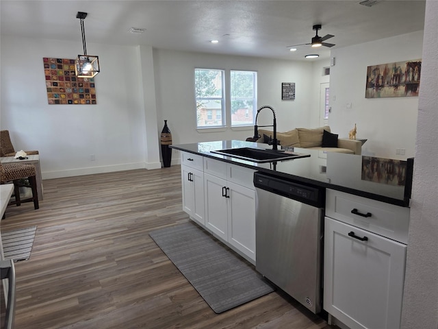 1941 Juniper Dr, Little Elm, TX 75068 - kitchen with stainless steel dishwasher, a sink, dark countertops, white cabinets, and recessed lighting