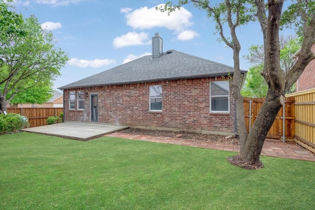 1941 Juniper Dr, Little Elm, TX 75068 - back of property featuring brick siding, a patio area, a chimney, and a shingled roof