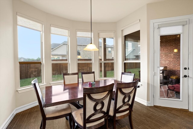 sunroom / solarium with baseboards and wood finished floors