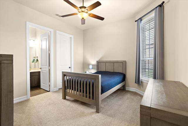 bedroom featuring ensuite bathroom, ceiling fan, carpet floors, baseboards, and visible vents