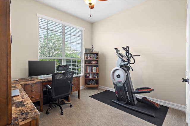 office with a ceiling fan, baseboards, and light colored carpet
