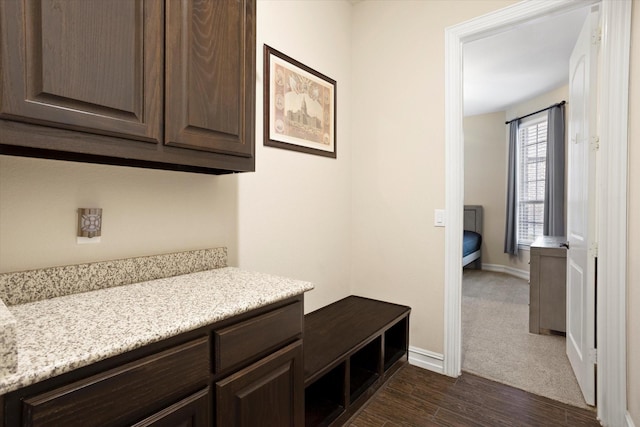 mudroom featuring baseboards and dark wood-style flooring