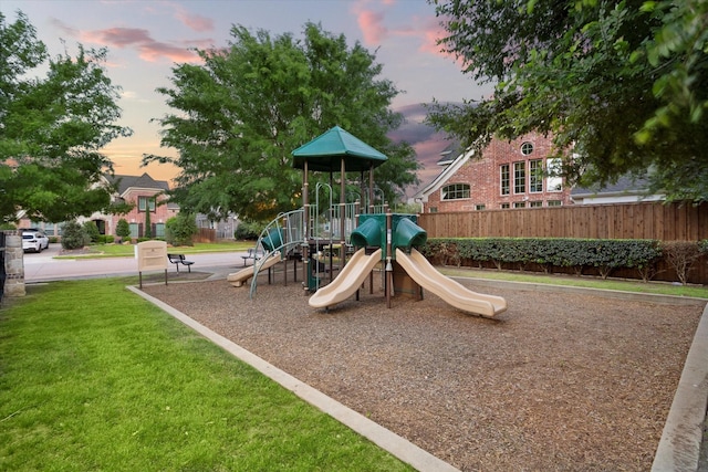 community playground featuring fence and a yard