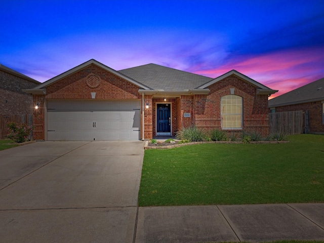 ranch-style house with concrete driveway, an attached garage, fence, a yard, and brick siding